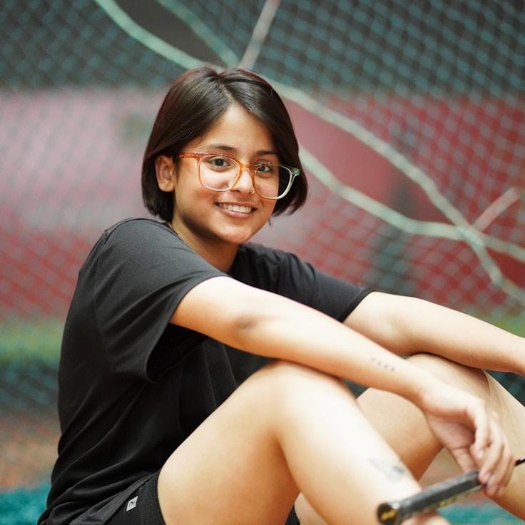 Avery Collins, Lead Design Curator at CalmStoneGarden, reviewing corporate floral arrangements